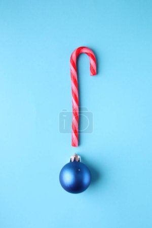 Photo for Merry Christmas creative card. Candy cane and Christmas Bauble. - Royalty Free Image
