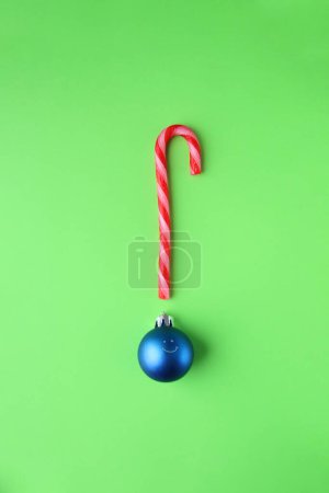 Photo for Merry Christmas creative card. Candy cane and Christmas Bauble with smile. - Royalty Free Image