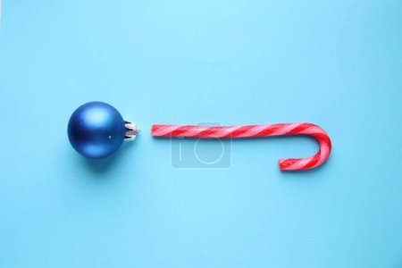 Photo for Merry Christmas creative card. Candy cane and Christmas Bauble. - Royalty Free Image