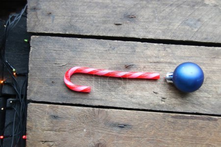 Photo for Merry Christmas creative card. Candy cane on a wooden background. - Royalty Free Image