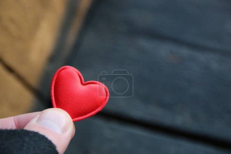 Photo for Human hand holding red toy heart. Valentine's Day concept. - Royalty Free Image
