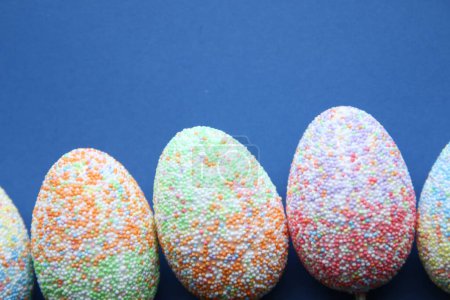 Photo for Easter holiday background with Easter eggs. Colorful Easter Eggs on Blue Background - Royalty Free Image