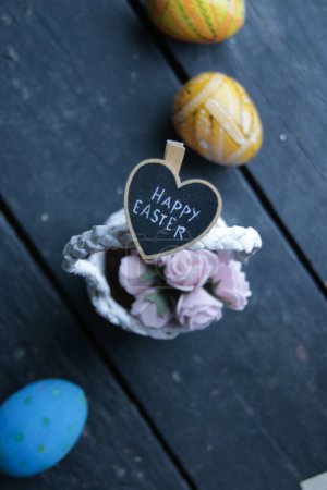 Photo for Happy easter concept, basket of flowers and lettering - Royalty Free Image