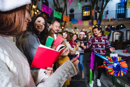 Photo for Mexican Posada, hispanic family Singing carols in Christmas celebration in Mexico Latin America culture and traditions - Royalty Free Image