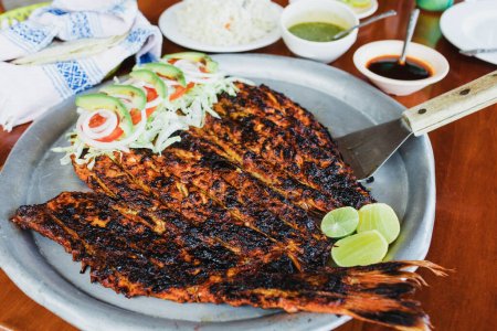 Photo for Grilled mexican fish traditional from Acapulco Mexico or barbecued fish called Pescado a la Talla - Royalty Free Image