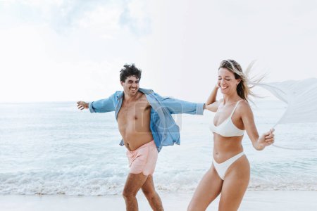 Photo for Hispanic young couple in love man and woman having fun on caribbean beach in holidays or vacations in Mexico Latin America - Royalty Free Image