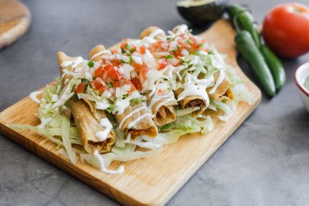 Mexican tacos dorados called flautas with chicken, traditional fried food in Mexico Latin America