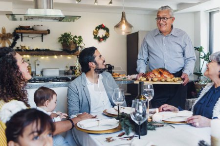 Photo for Latin family having thanksgiving dinner at home in Mexico Latin America, hispanic people eating at holidays - Royalty Free Image