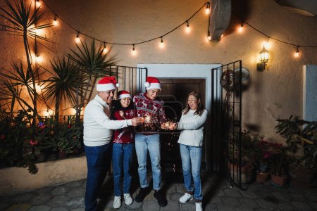 Photo for Latin family with sparkling lights and Singing carols in Christmas eve celebration in Mexico, Latin America culture and traditions, Mexican Posadas - Royalty Free Image
