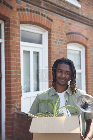 Portrait Of Young Man Or Student Moving Into House Flat Or Apartment Whilst Studying At University Or College 