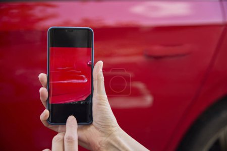 Foto de Primer plano del conductor tomando fotos de daños al coche después de un accidente en el teléfono móvil - Imagen libre de derechos