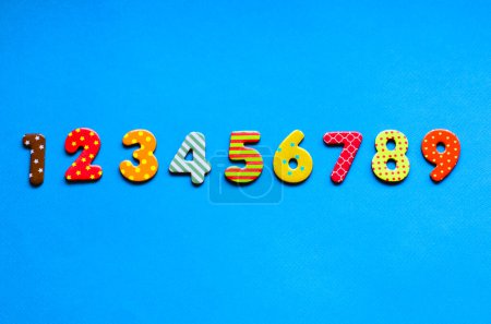 Photo for Numbers from one to nine  one on blue paper background - Royalty Free Image