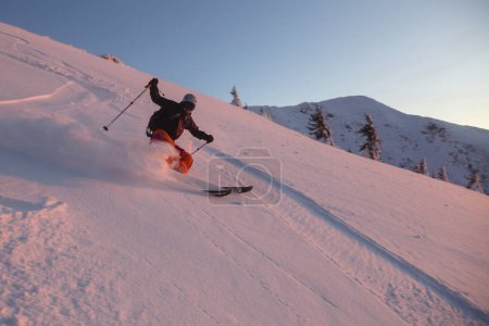 Photo for Marmaros, The Carpathians, UKRAINE - FEB 12 2021: Skier skiing downhill in high mountains - Royalty Free Image