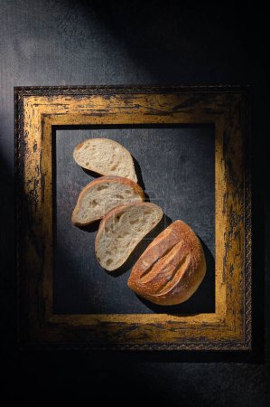 Photo for Sliced Homemade Sourdough Rye Bread Top View Inside of Classic Frame - Royalty Free Image