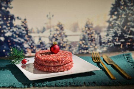Photo for Abstract Beef Raw Minced Homemade Meat with  Red Christmas Ball onTop - Royalty Free Image