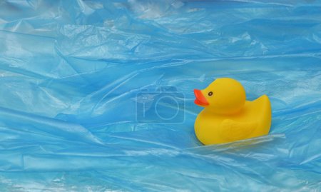 Photo for Concept Pollution Plastic In Sea with Yellow Rubber Duck Toy and Plastic Waves - Royalty Free Image