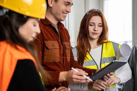 Photo for Engineer supervisor at construction site with his female work team setting guidelines in building site office - Teamwork concept - Royalty Free Image