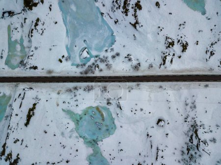 Foto de Drone aerial top view of Winter landscape in Lofoten Islands, Norway. Color horizontal photography with amazing abstract effect. Snow and ice in wild nature. - Imagen libre de derechos