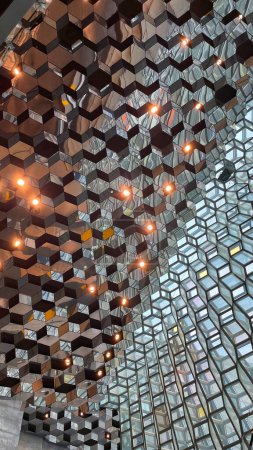 Téléchargez les photos : Glass wall of Harpa concert hall, Reykjavik, Iceland. Colorful glass windows with abstract geometry. Modern art at amazing travel destination and tourist attraction in the Nordic country. - en image libre de droit