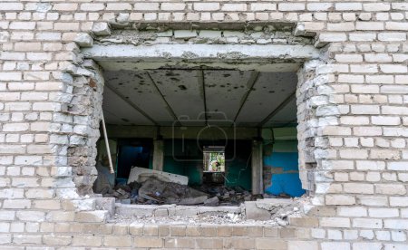 Photo for Bomb hole in the wall destroyed school building war in Ukraine - Royalty Free Image