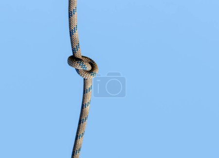 Photo for Knot on a rope on a blue background close up - Royalty Free Image