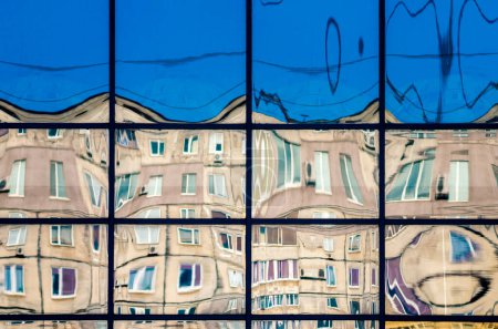 Photo for Crooked reflection of houses in the glass of the window abstract colored background - Royalty Free Image