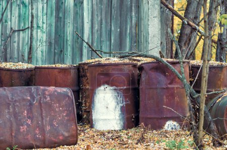 Photo for Old barrels of chemical waste and chlorine in the forest in Chernobyl Ukraine in autumn - Royalty Free Image