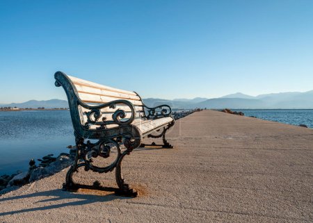 Photo for Vintage bench on the pier of the Aegean Sea in Athens Greece - Royalty Free Image