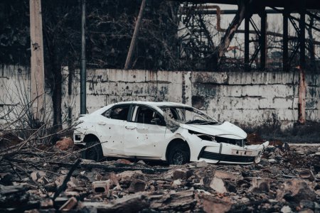Photo for Car and destroyed buildings of the workshop of the Azovstal plant in Mariupol war in Ukraine with Russia - Royalty Free Image