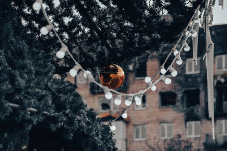 Photo for Christmas tree with toys near the house in the ruined city of the war in Ukraine - Royalty Free Image