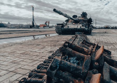 damaged military tank on the city street war in Ukraine with Russia