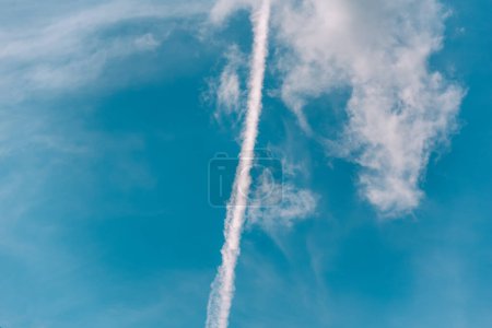 Photo for Contrail of a rocket launch in the blue sky war in Ukraine - Royalty Free Image