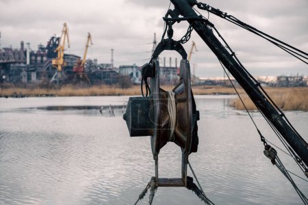 ship equipment against the background of the destroyed Azovstal plant in Ukraine close up