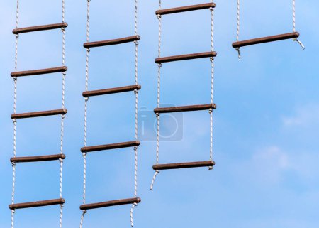 rope ladder against a blue sky and clouds