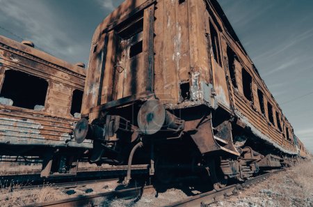 end of the road damaged and burnt trains war in Ukraine with Russia