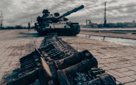 damaged military tank on the city street war in Ukraine with Russia