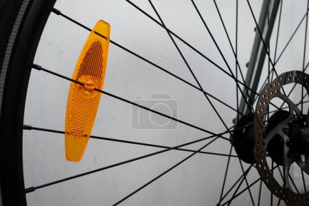 Photo for Bike reflector. Bicycle front wheel hub. Attachment of bicycle spokes. Safe driving. - Royalty Free Image