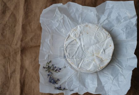 Photo for French Camembert cheese, dry lavender. Brown linen tablecloth. Packaging. - Royalty Free Image