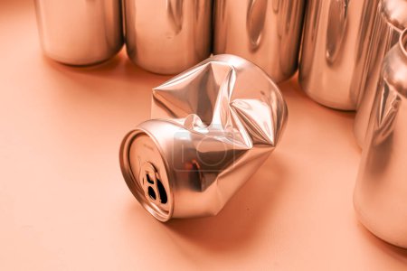 The crumpled empty drink can or aluminum beverage can. Peach fuzz color. Copy space.