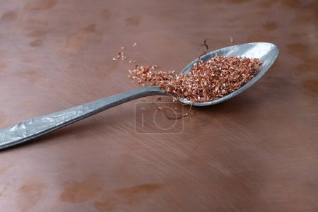 Copper shavings. Aluminum spoon. Copper background. Nonferrow metals. Copy space.