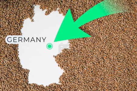 Map of Germany filled with wheat grain. Direction green arrow. Copy space.