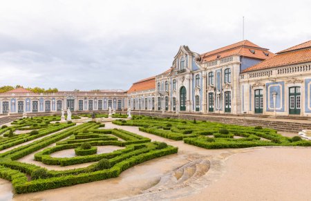 Photo for Queluz Palace, Sintra; Portugal; October 20, 2022. The exterior palace walls showcasing Rococo styled architecture which borders a beautiful garden and water fountains. - Royalty Free Image