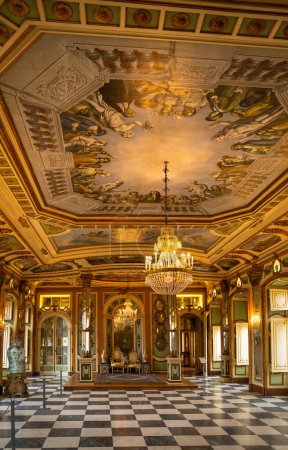 Photo for Queluz Palace, Sintra; Portugal; October 20, 2022. The Throne Room at the Queluz Palace. The king and queens' thrones placed at one end of the room. This room is decorated with paintings, chandeliers and mirrors. - Royalty Free Image