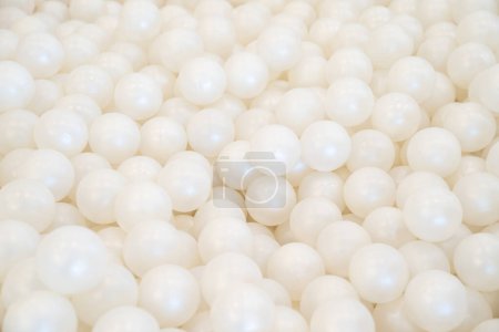 Photo for Background of many shiny white plastic balls in a ball house. It likes a many pearl  in the pool. - Royalty Free Image