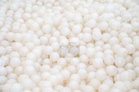 Photo for Background of many shiny white plastic balls in a ball house. It likes a many pearl  in the pool. - Royalty Free Image