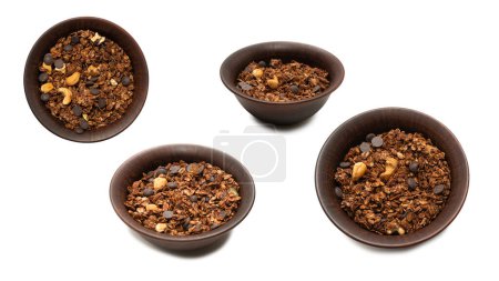 Chocolate granola cereal with nuts in a bowl background. Isolated on white bacckground. 