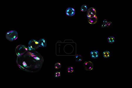 Soap bubbles isolated on a black background. Copy space.