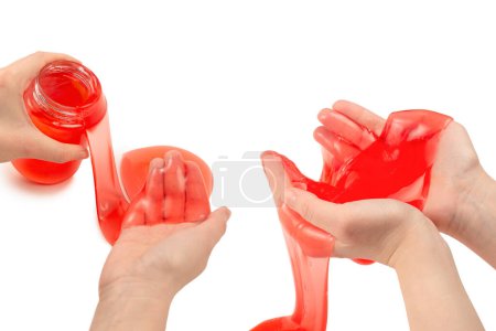 Red slime toy in woman hand isolated on white. Top view. 