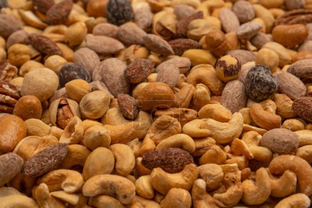 Mix of tasty salty nuts.  A group of almonds, pistachios, walnuts, macadamia, cashews.