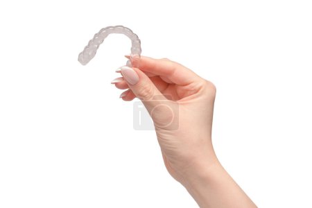 Photo for Transparent mouth guard in a woman's hand isolated on a white background. - Royalty Free Image